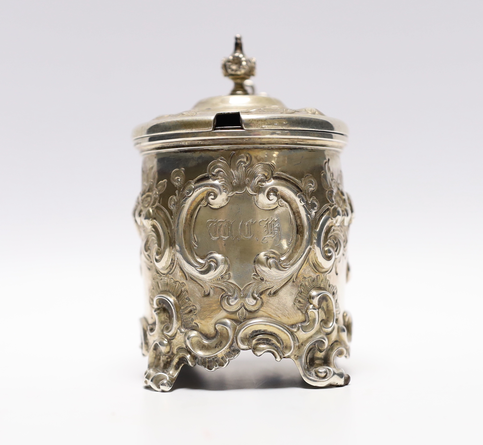 A Victorian embossed silver drum mustard, John Evans II, London, 1863, decorated with foliage and scrolls.